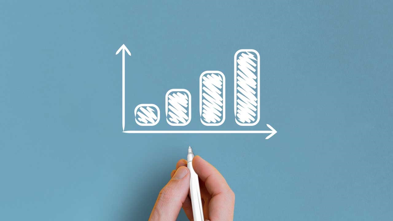 Geldanlage mit Sparplan Eine Hand zeichnet ein Balkendiagramm